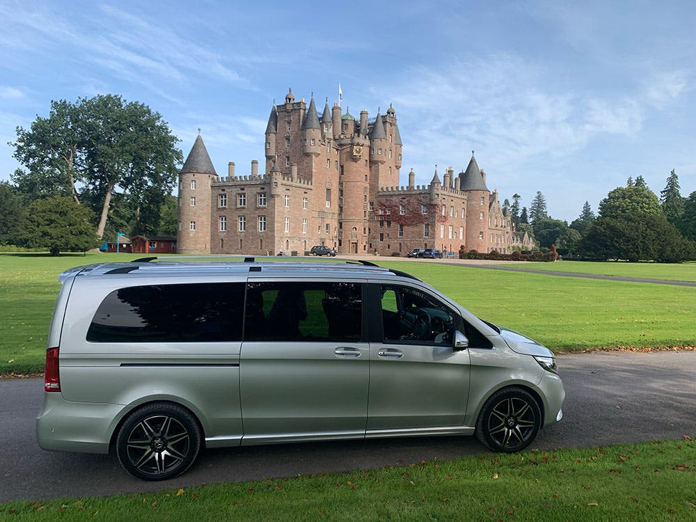 Van parked next to a castle