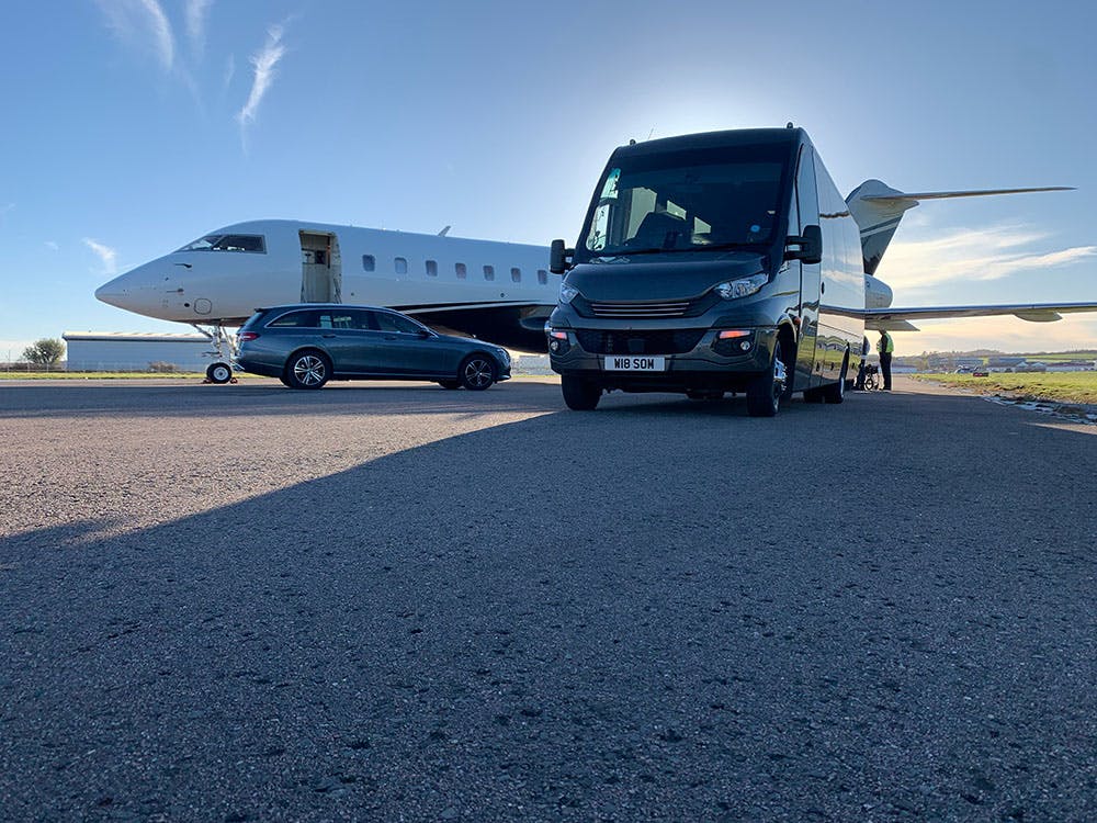 Bus by a private jet
